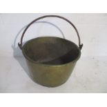 A large 19th Century brass cauldron with iron handle, height 37cm, diameter 56cm