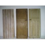 A pair of pine panelled doors, along with one other