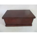 A large dark wood blanket box