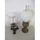 One brass Oil Lamp, plus another oil lamp on a metal tripod base.