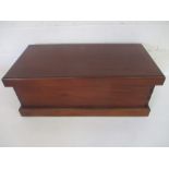 A dark wood blanket box