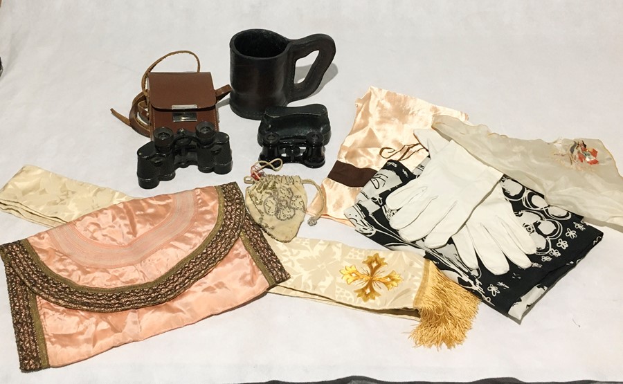 A collection of various items including binoculars, scarves,a leather jack, handkerchiefs etc