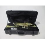 A Stagg Trumpet 77-T (Serial No. ND0418D) in carry case, along with three "How to play Trumpet"