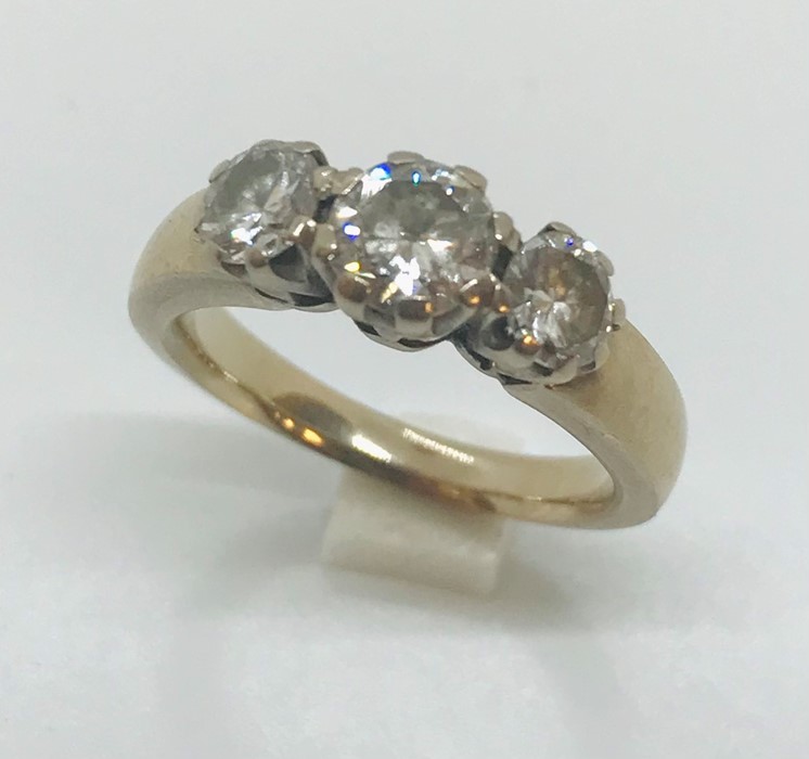 A substantial unmarked white gold ( tested as 18ct) diamond three stone ring of approximately 1ct