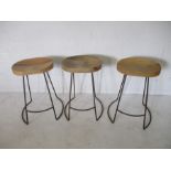 Three contemporary wooden stools with wrought iron legs