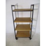 An industrial metal framed moveable shelving unit