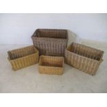A collection of four various sized wicker baskets