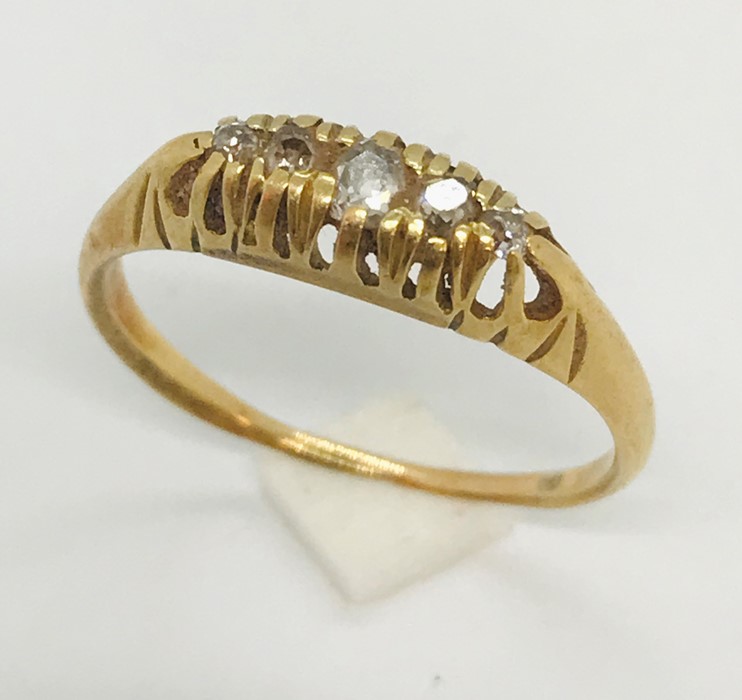 An unmarked ( probably 18ct gold) boat ring set with 5 diamonds
