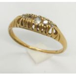 An unmarked ( probably 18ct gold) boat ring set with 5 diamonds