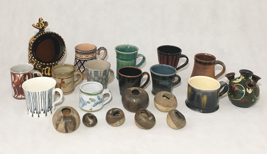 A collection of studio pottery style mugs etc