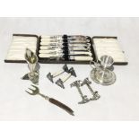 A collection of silver plated items including cutlery set, decorative door handles etc