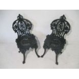 A pair of heavy cast iron garden chairs