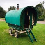 A bow top gypsy caravan painted green with typical decoration. Hand built circa 2009. Wood burning