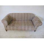 An Edwardian drop arm sofa