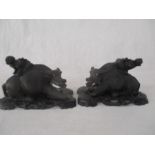 A pair of early 20th Century hardwood carved buffalo on stands- damage to horns