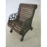 An antique cast iron garden chair with wooden slatted seat - registered number to plaque 525551