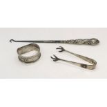 A collection of three silver items comprising of sugar tongs, button hook and napkin ring