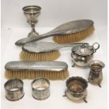A collection of silver items including brushes, serviette rings, salt and pepper etc.