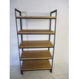 An industrial metal framed moveable shelving unit