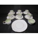 A Susie Cooper part tea set including 6 trios (2 cups A/F), a creamer, sugar bowl and plate.