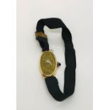 An 18ct gold ( hallmarked rubbed) ladies cocktail watch with cabochon sapphire winder