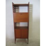 One section of Staples Ladderax unit furniture with a fall front desk and one cupboard