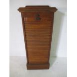 A Tambour fronted music cabinet with adjustable top/music stand and five drawers within. W50cm D43cm
