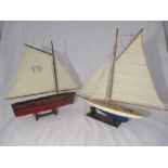 Two wooden models of sailing boats