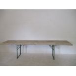 A large trestle table with folding metal base - overall length 3.24 metres