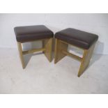 A pair of upholstered Warings oak stools
