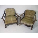 A turn of the century pair of wooden framed armchairs