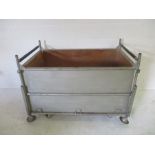 A metal industrial stackable trolley with ply lining, 127cm x 78 cm