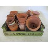 A collection of terracotta garden pots in a wooden crate (crate stamped J.C.Hammond & Son 1990)