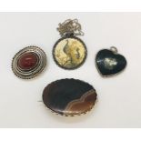 Two silver brooches along with two silver pendants