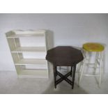 A painted bar stool, along with a small painted bookcase and occasional table