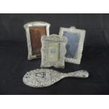 Three hallmarked silver photo frames along with a silver backed hand mirror all A/F