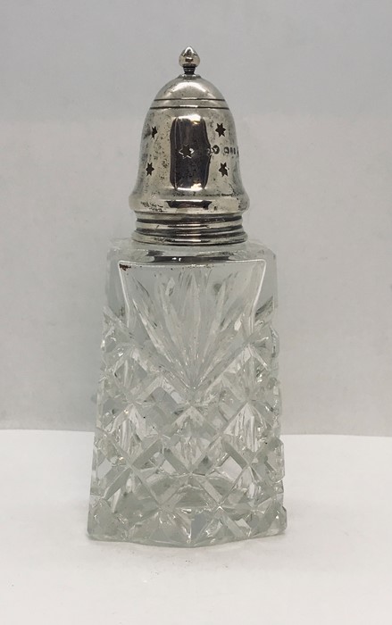 A hallmarked silver topped sugar castor