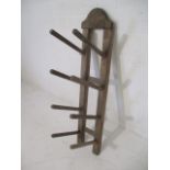 A vintage wooden wall hanging boot rack