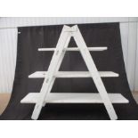 A painted ladder style display unit.