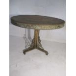 A brass topped eastern table on a wrought iron base.