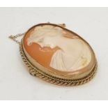 A cameo of a lady set in 9ct gold with safety chain
