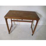 A mid-century McIntosh & Co Ltd teak tea table with fold over top