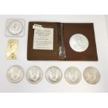 A collection of silver coins comprising of five Liberty Dollars, a 1991 Australian 5 dollar