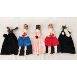 A collection of Punch and Judy puppets with wooden heads and hands including a dog, cat, two