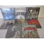A collection of eight heavy rock 12" vinyl records including Jethro Tull, Guns N' Roses, Uriah Heap,