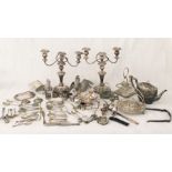 A collection of silver plated items including candlesticks, fighting cocks, napkin rings etc.