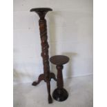 A Victorian style torchere decorated with trailing vine leaves and grapes along with a similar plant