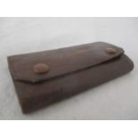 A vintage leather cased travel domino set