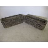 A pair of concrete garden troughs