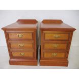 A pair of bedside cabinets